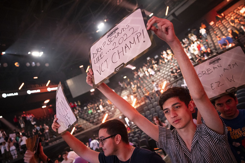 A fan holds up a sign reading 'DRX? sounds like... 2022 VCT champ!'