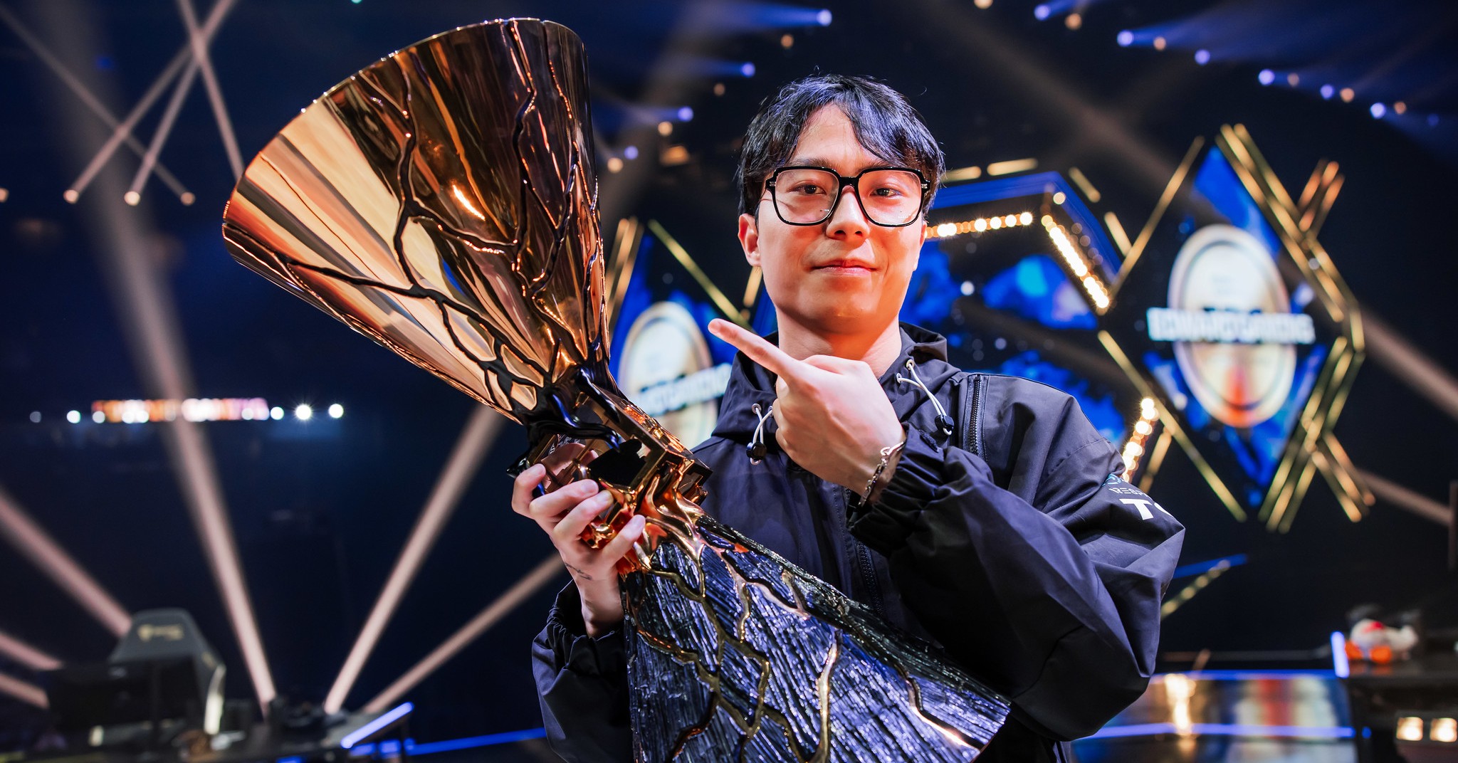 Muggle holding Champions 2024 trophy